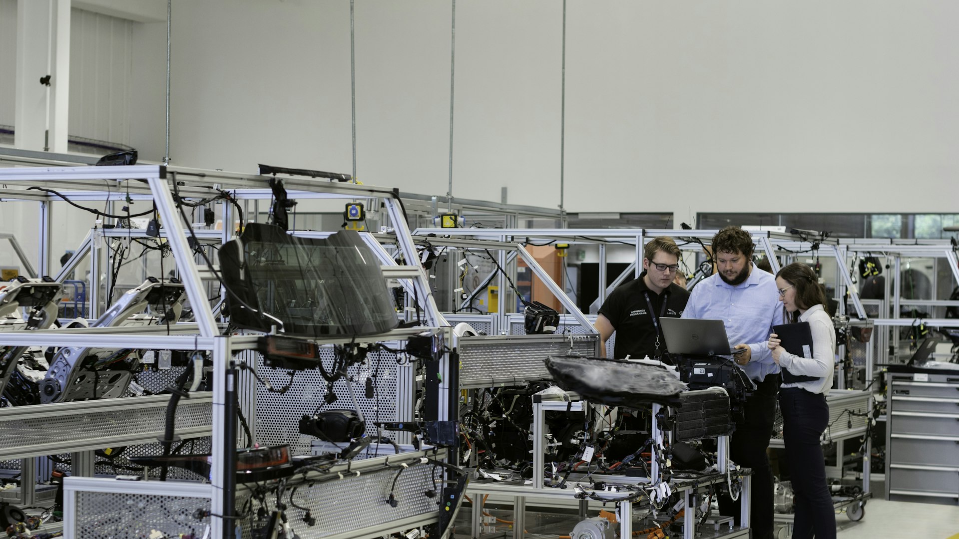 Engineers reviewing AI systems on a modern production floor